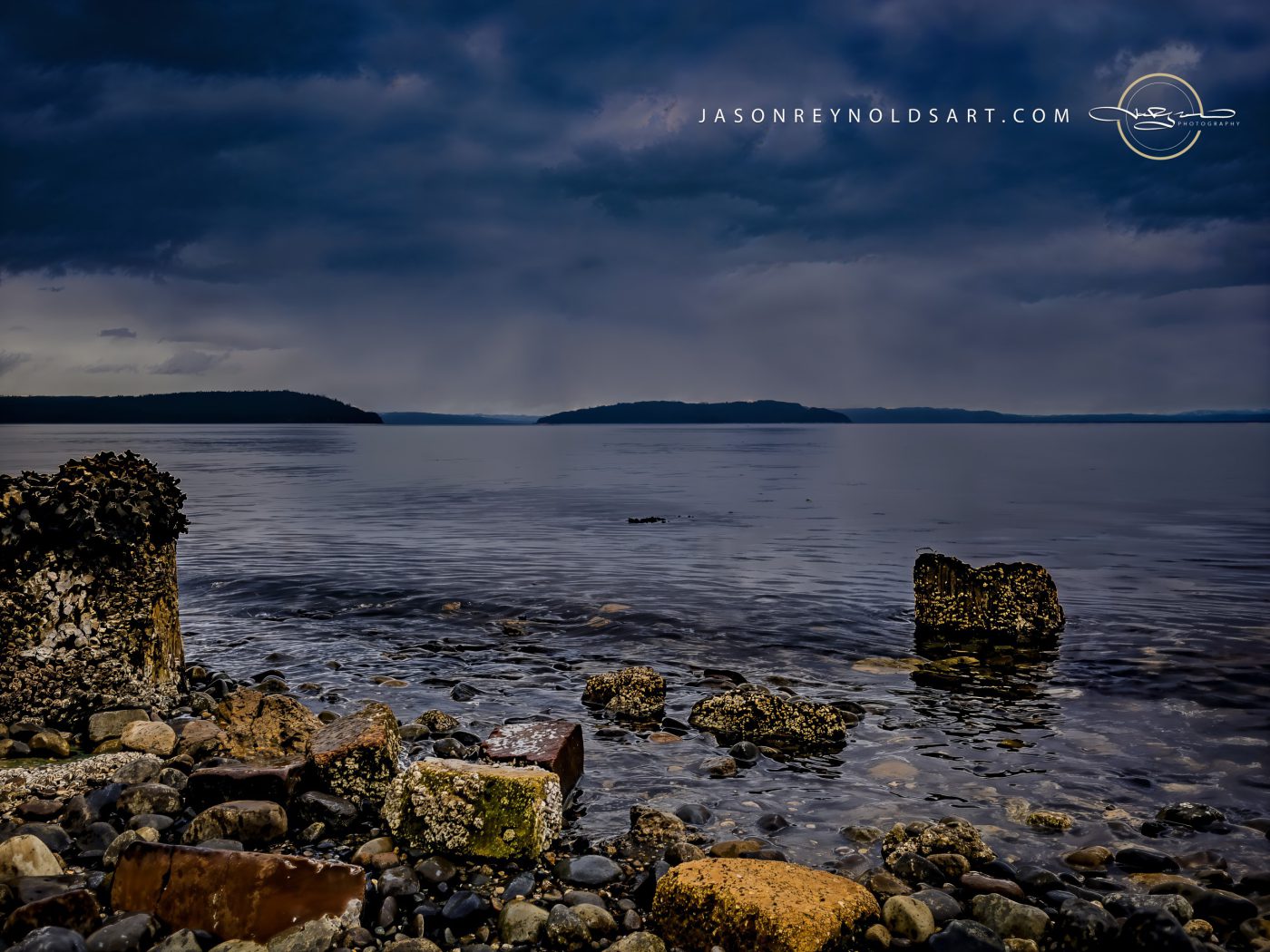Barnacled Rocks on a Calm Seaside beneath Storm Clouds