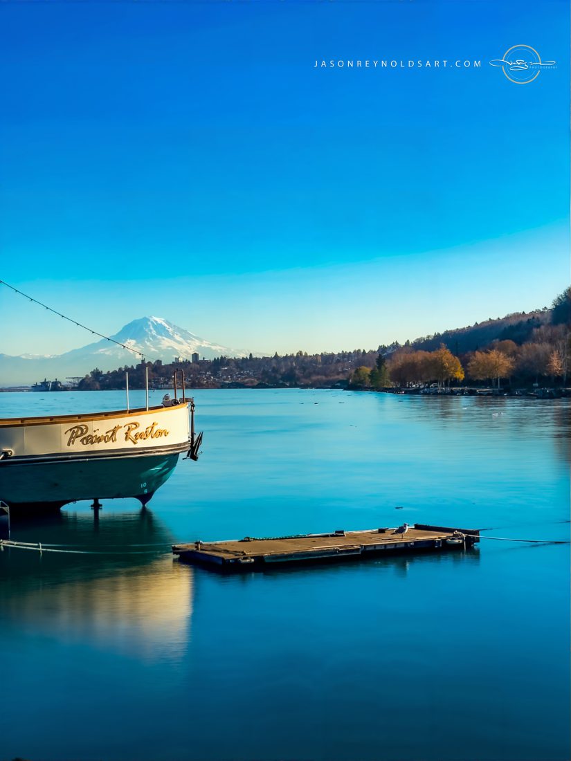 Boat and Floating Dock on Calm Blue Water with Mount Rainier beyond