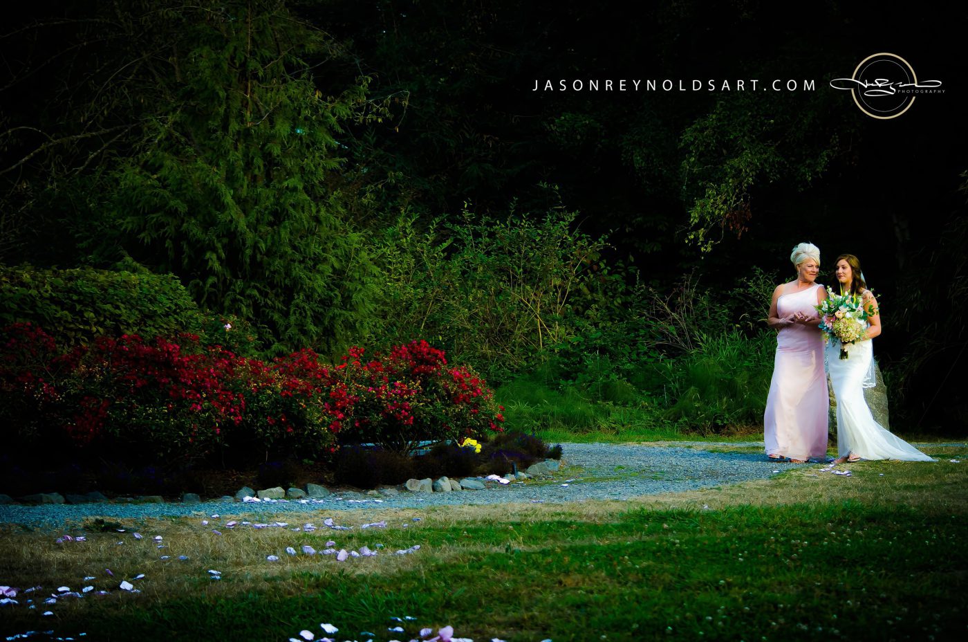 Bride and Attendant Walking on Garden Path