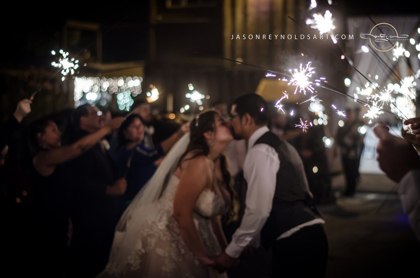 Bride and Groom Kiss Amid Sparkler Exit
