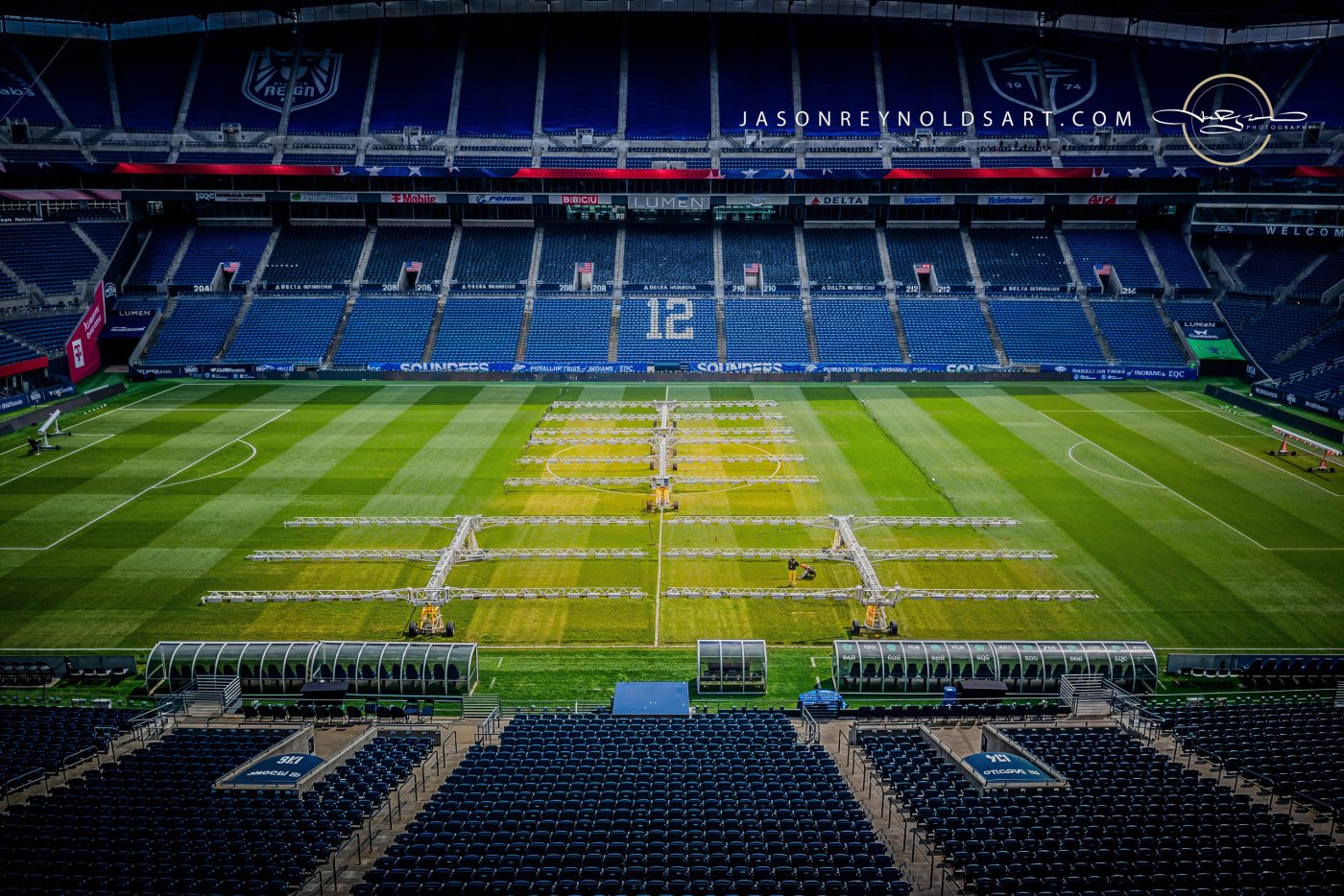 Empty stadium soccer pitch with centerline grow-light rigs