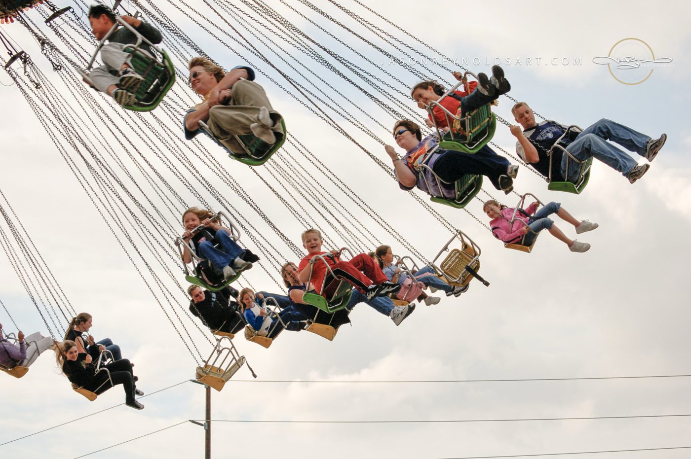 Fair swing ride with riders suspended mid-air