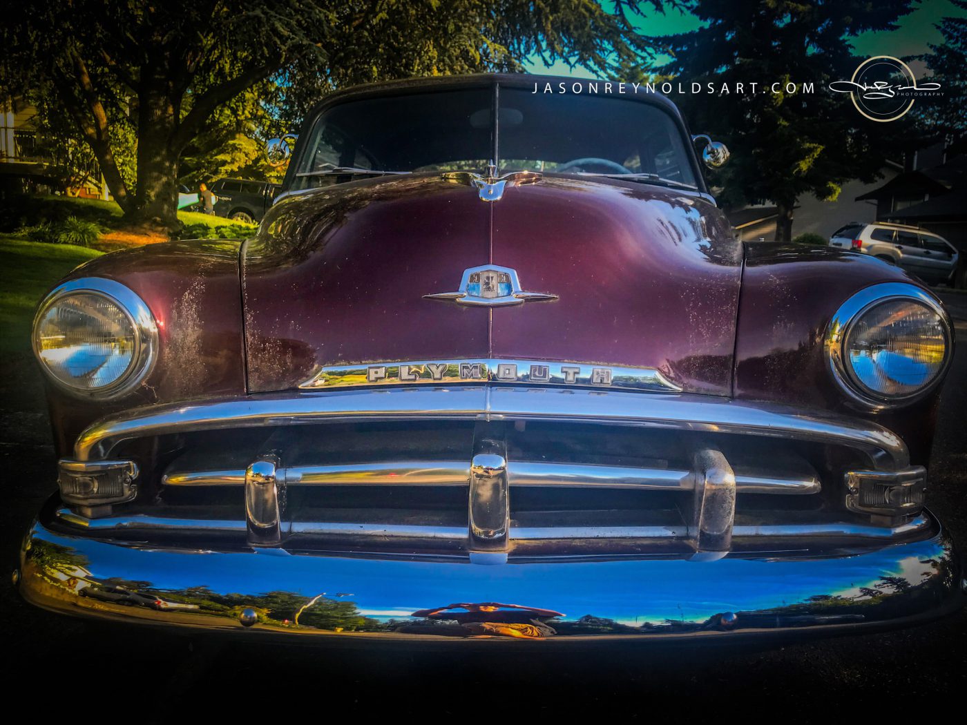 Front‑on Plymouth — maroon classic with chrome bumper