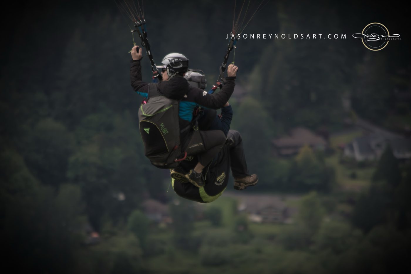 Issaquah Tandem Paragliders Over Forested Valley
