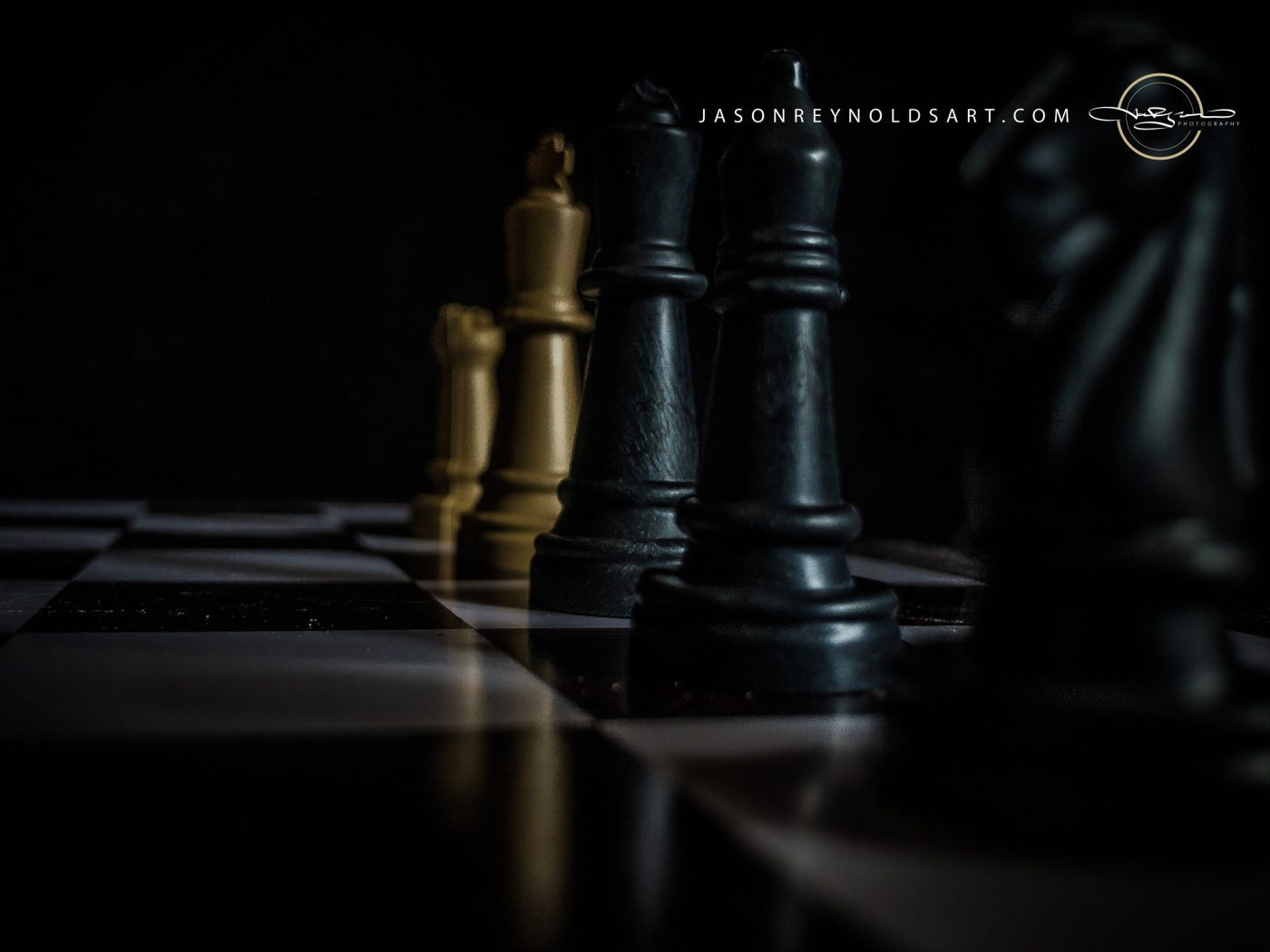 Low-angle study of black and gold chess pieces