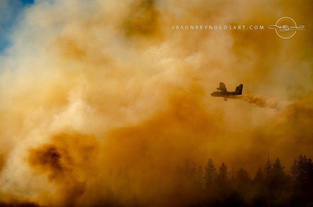 Spokane Valley Airtanker Dropping Retardant through Orange Smoke
