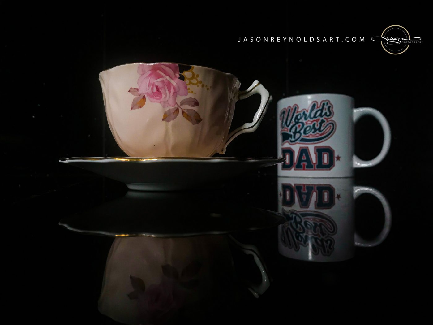 Pink Rose Teacup and 'World's Best Dad' Mug on Black Reflective Surface