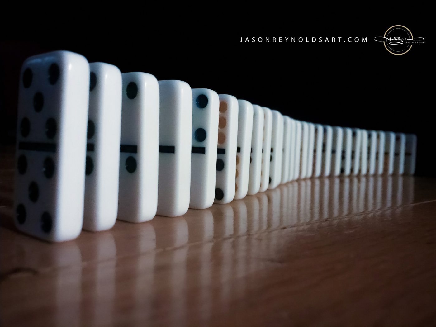 Row of White Dominoes on Wood