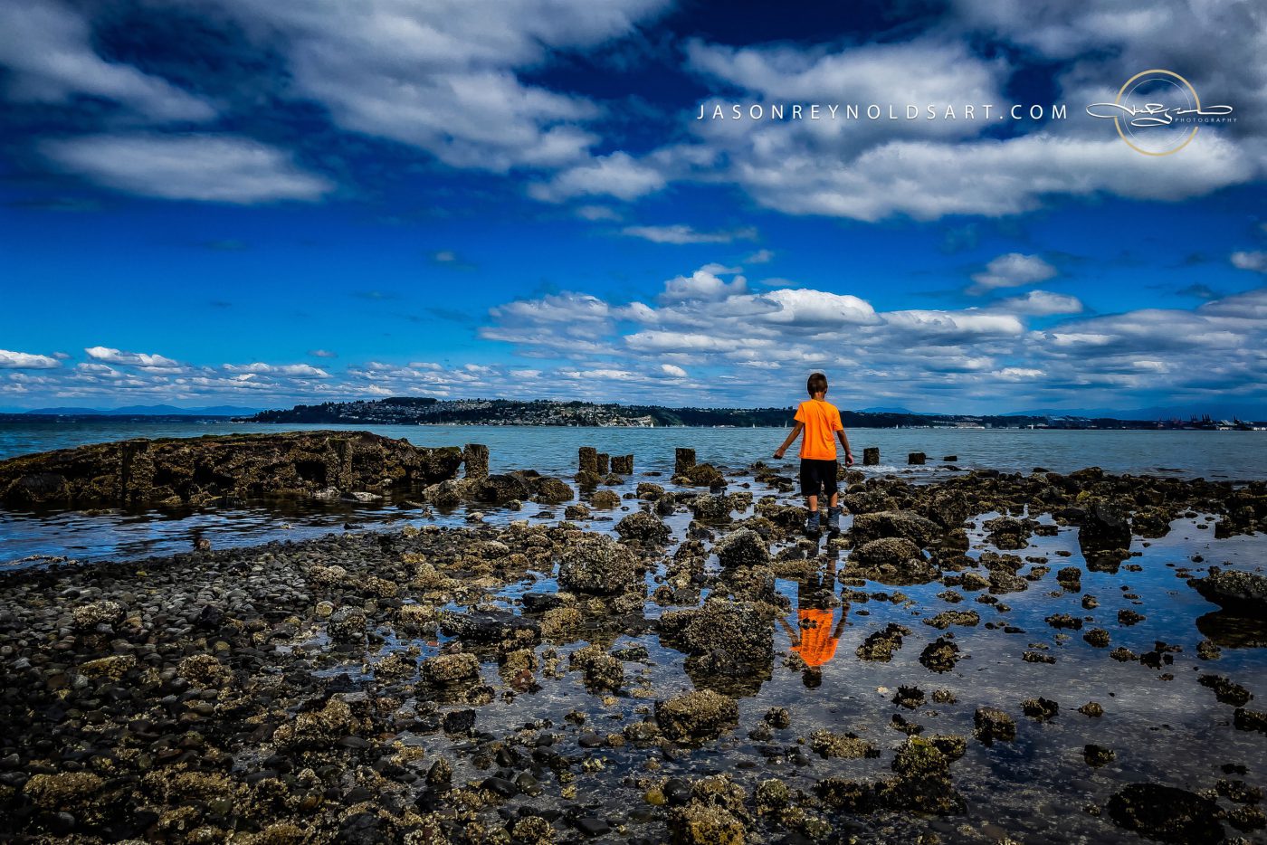 Ruston shoreline: child in orange shirt on rocky tideflats