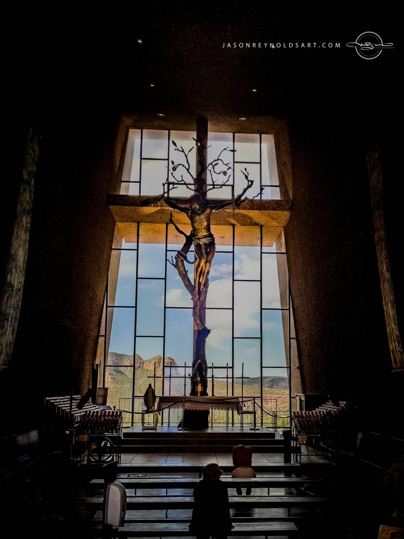 Sedona — Chapel of the Holy Cross crucifix framed by red‑rock window