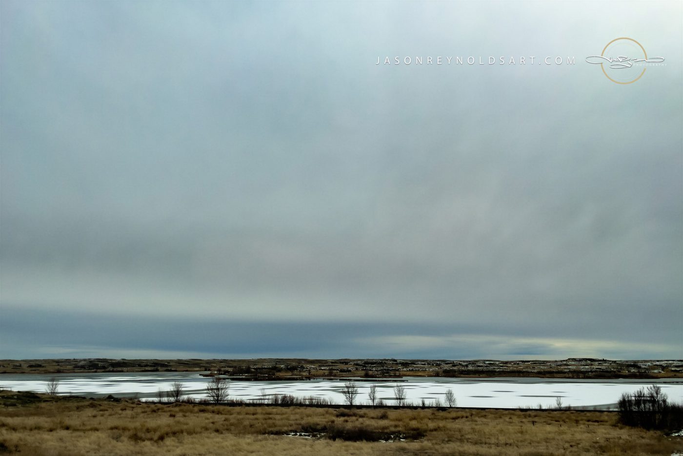 Sprague — Frozen Lake and Prairie Under Overcast Sky