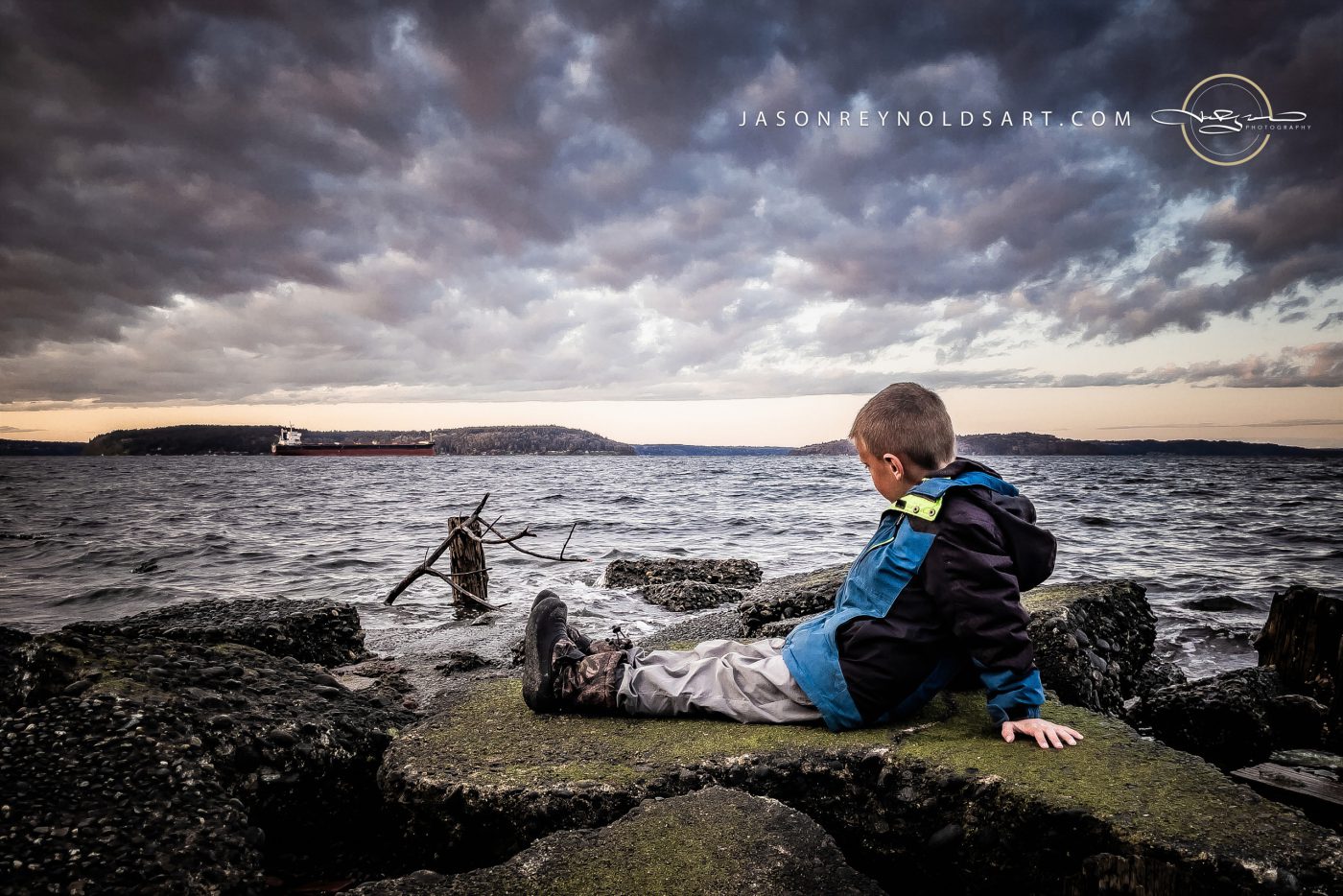 Tacoma North End — Child on the Shoreline Beneath Dramatic Clouds