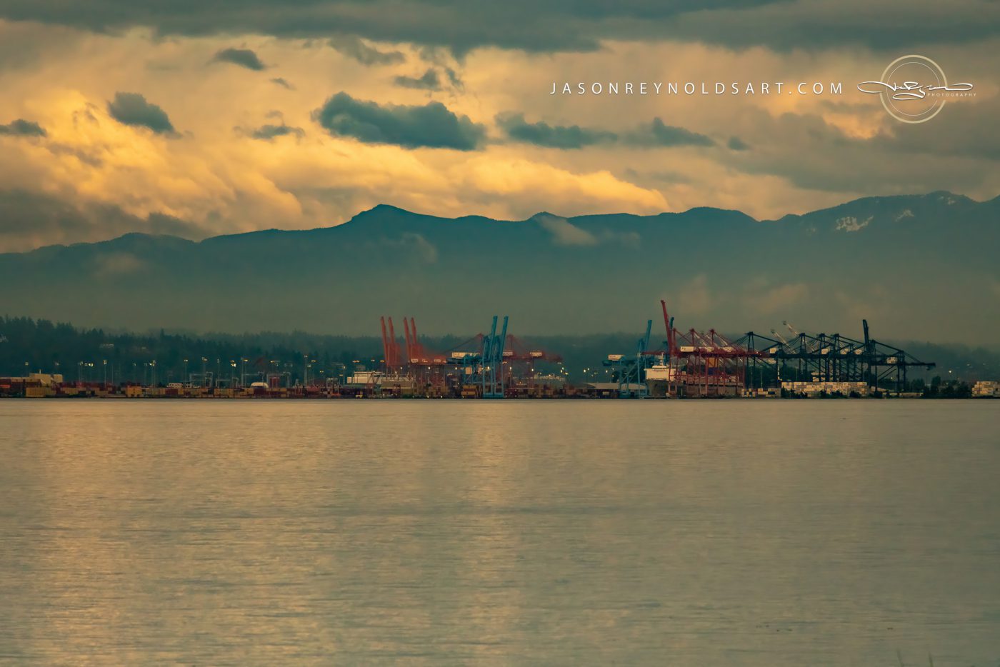 Tacoma waterfront with port cranes and mountain silhouette