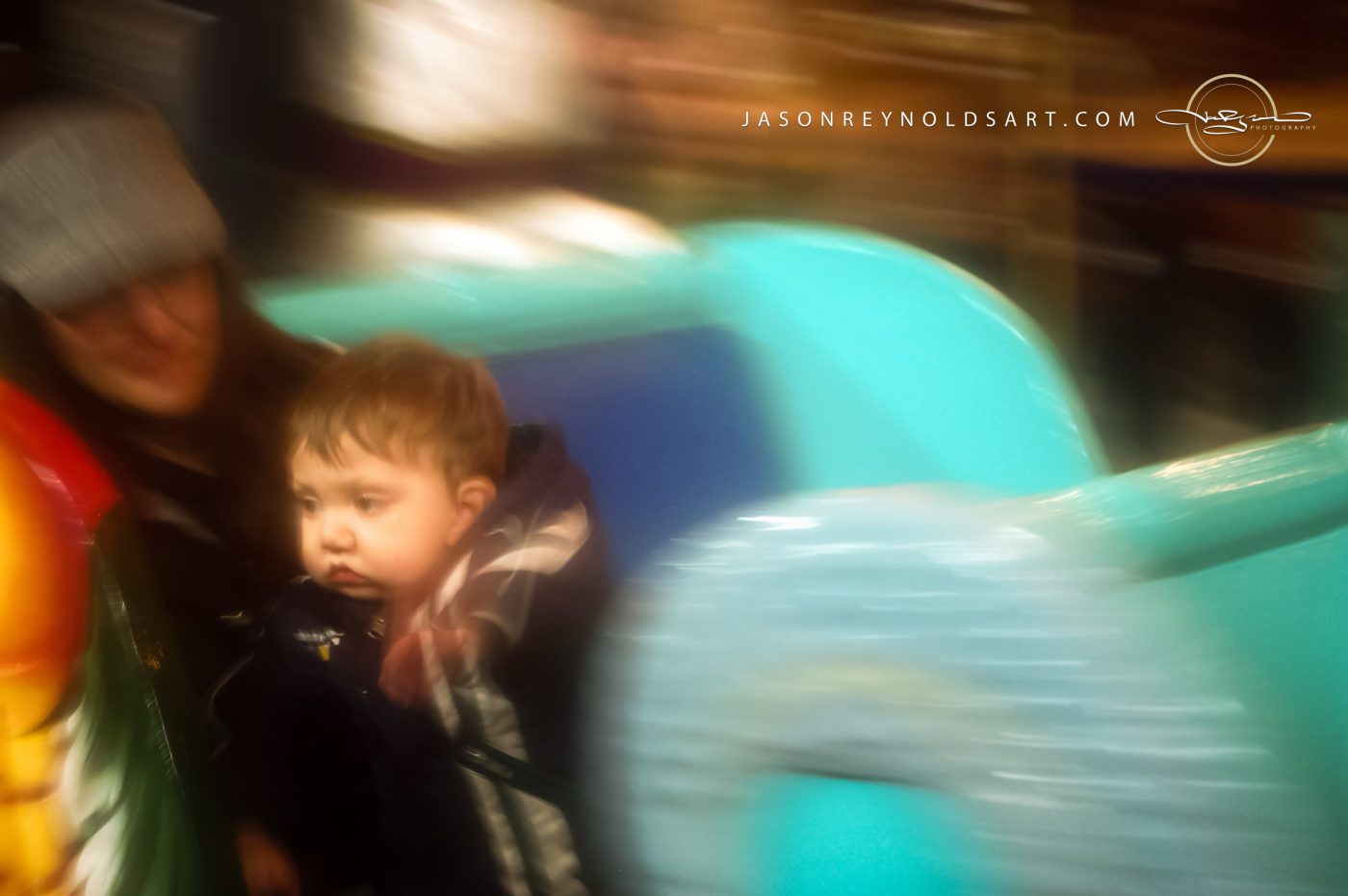 Toddler on Teal Ride — Motion-Blur Portrait