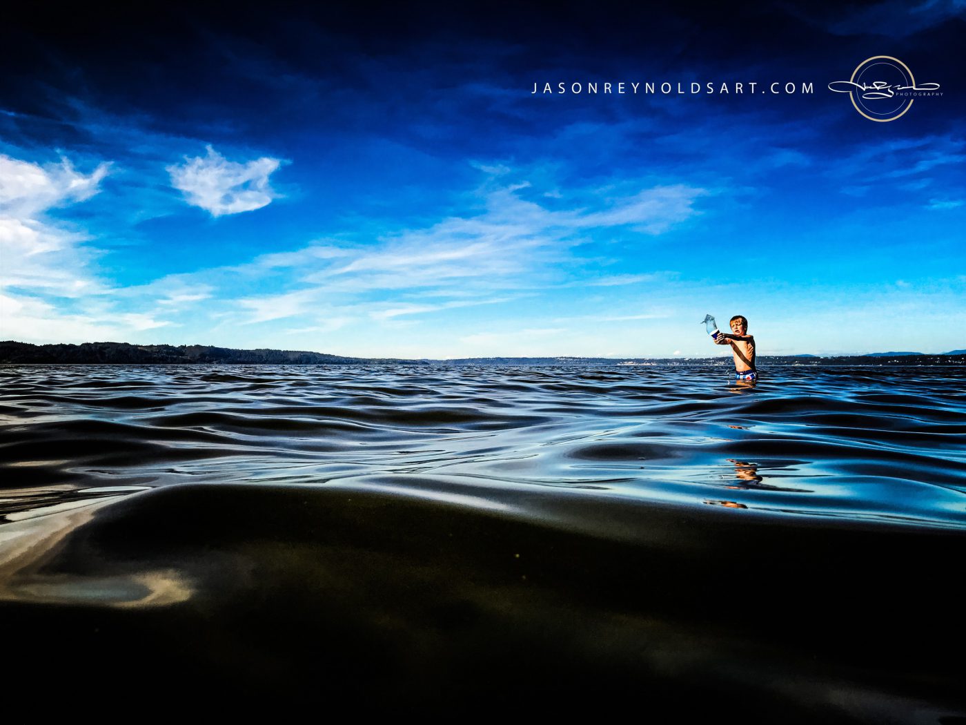 Washington — Boy playing in Puget Sound