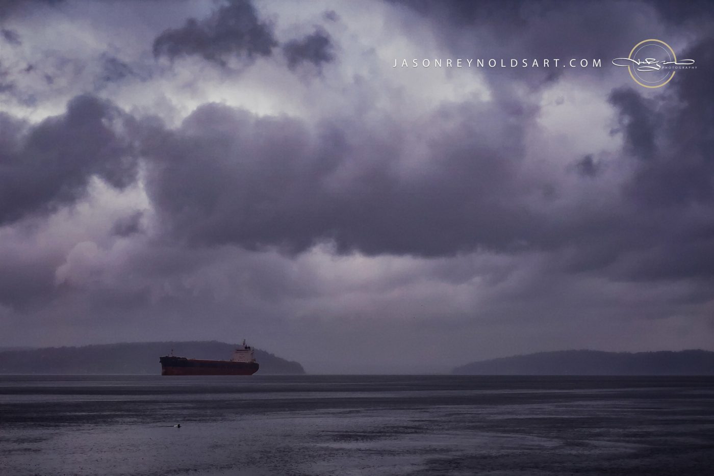 Washington coast: cargo freighter beneath heavy storm clouds